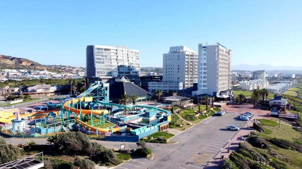 Aerial view of beachfront town with water park and apartment buildings