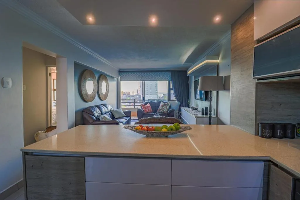 Modern kitchen island with breakfast bar overlooking lounge area with city views