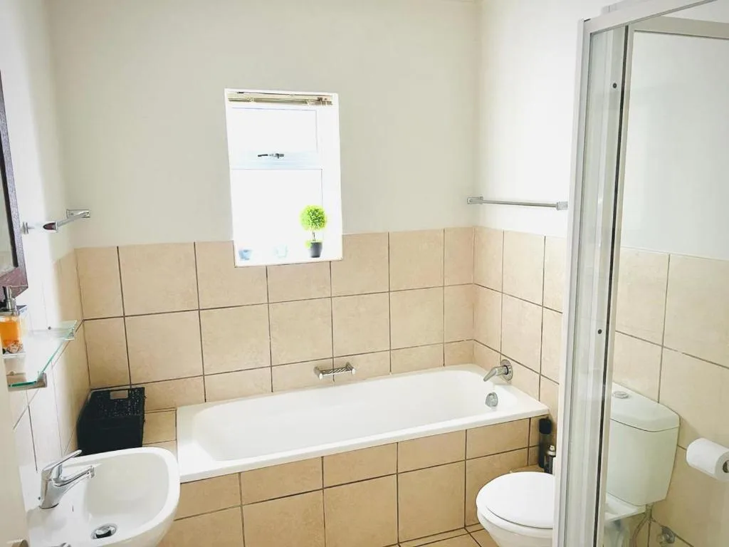Bathroom with bathtub, toilet, sink, and shower enclosure