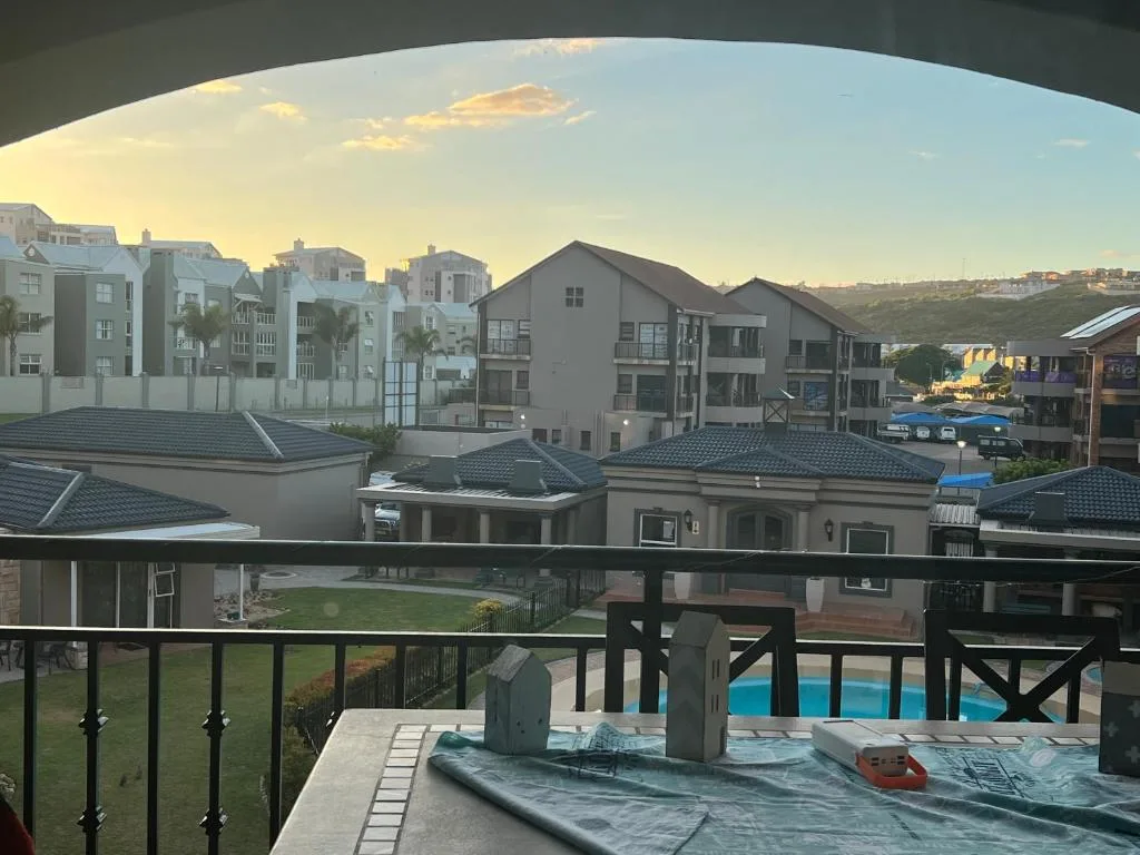 Scenic coastal town view from balcony with buildings and lagoon beyond