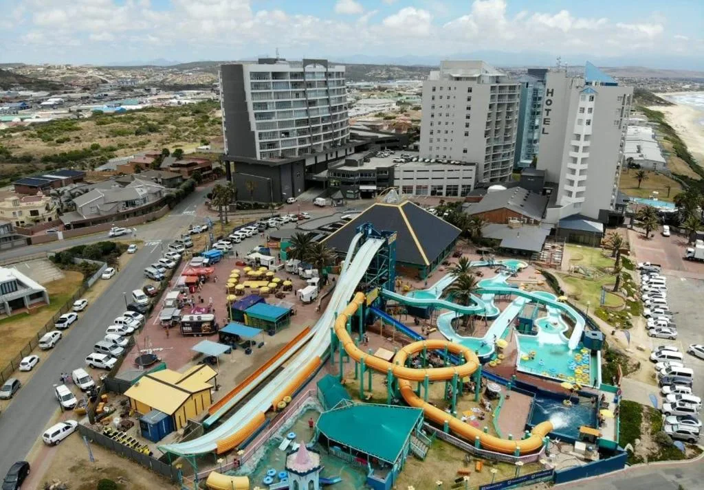 Aerial view of beachfront resort with water park and hotel buildings