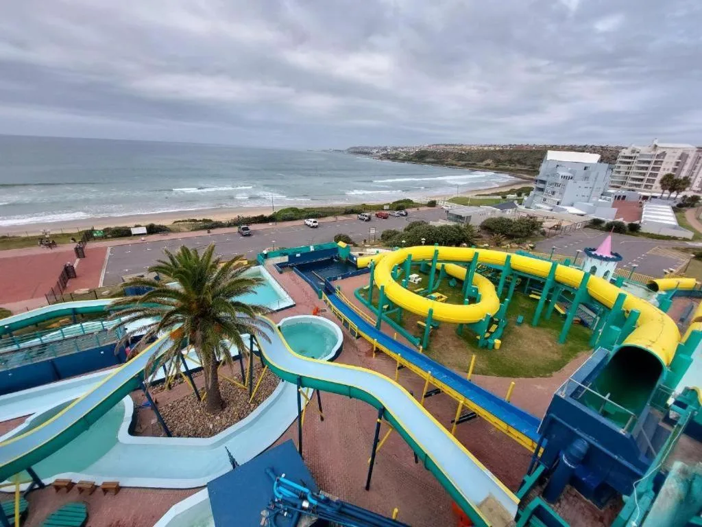 Colorful water park with slides overlooking Mossel Bay beach and ocean
