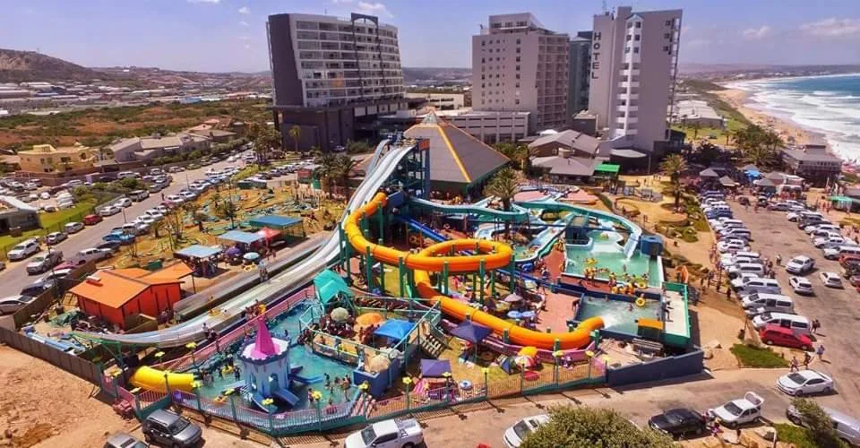 Aerial view of beachfront property with water park and ocean beyond