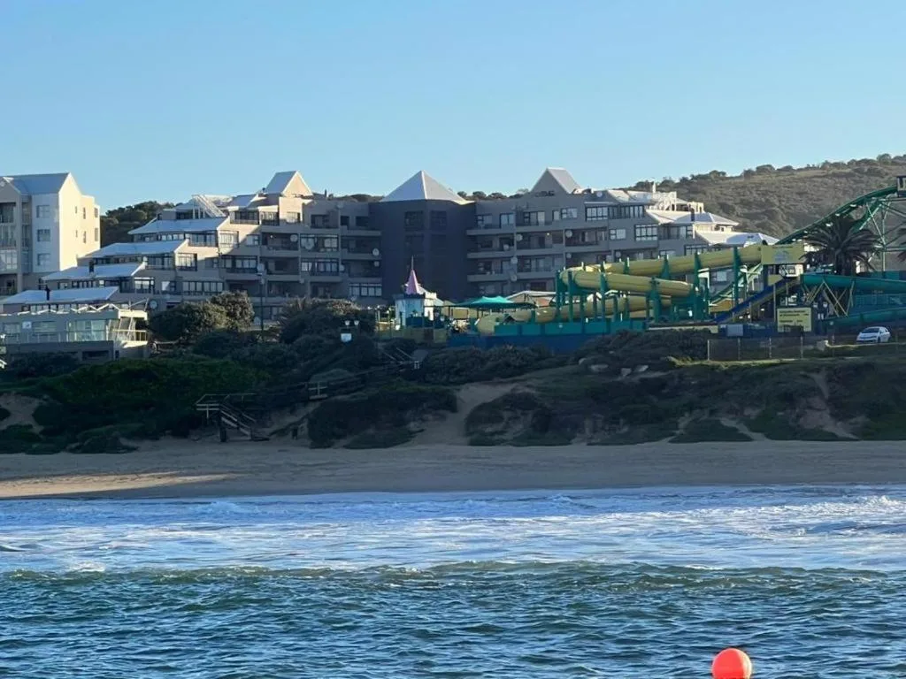 Beachfront resort buildings with ocean and sandy beach view