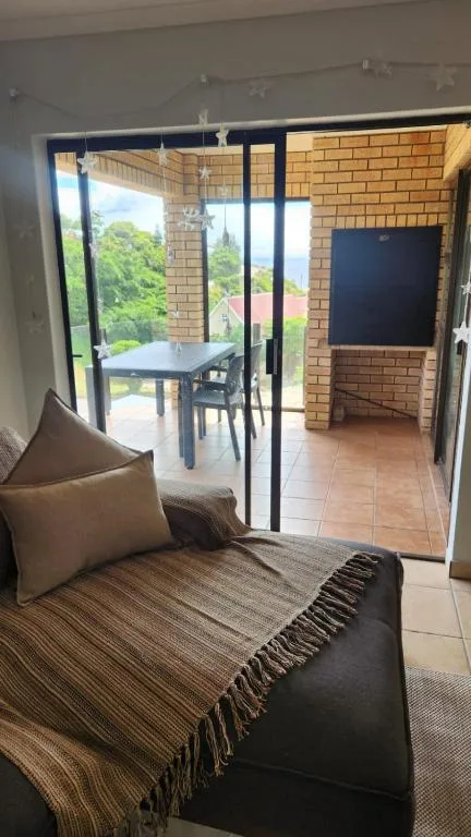 Comfortable lounge with sofa overlooking deck and garden views