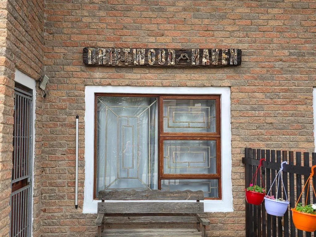 Brick building entrance with wooden window frame and signage