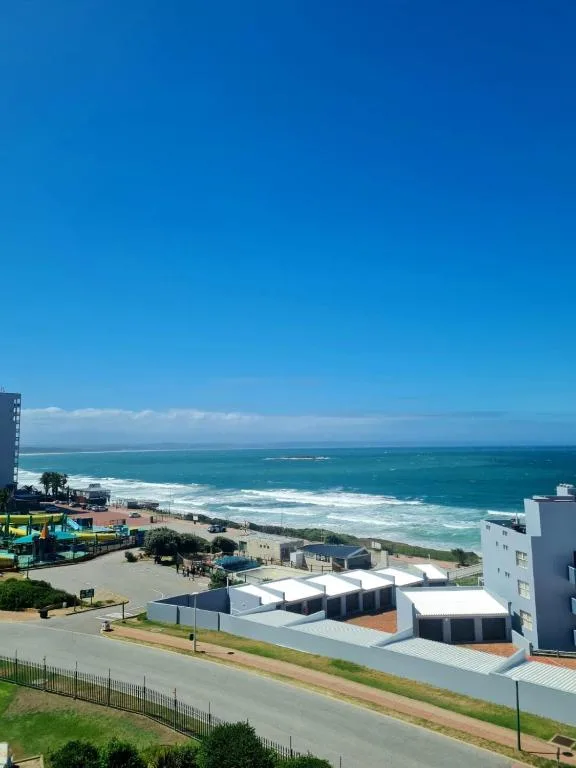 Expansive ocean and beach view from elevated coastal apartment balcony