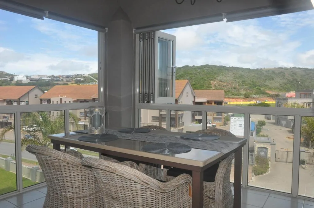 Covered outdoor deck with braai station overlooking valley and mountains