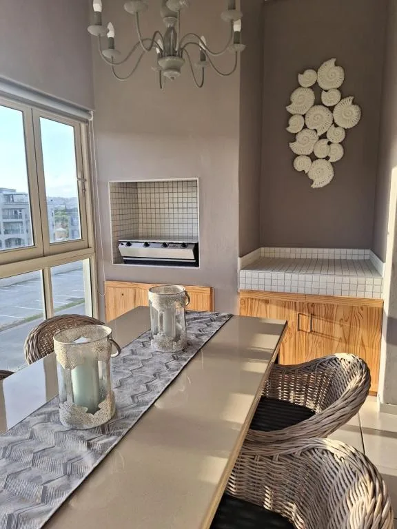 Modern dining area with wicker chairs and coastal decor accents