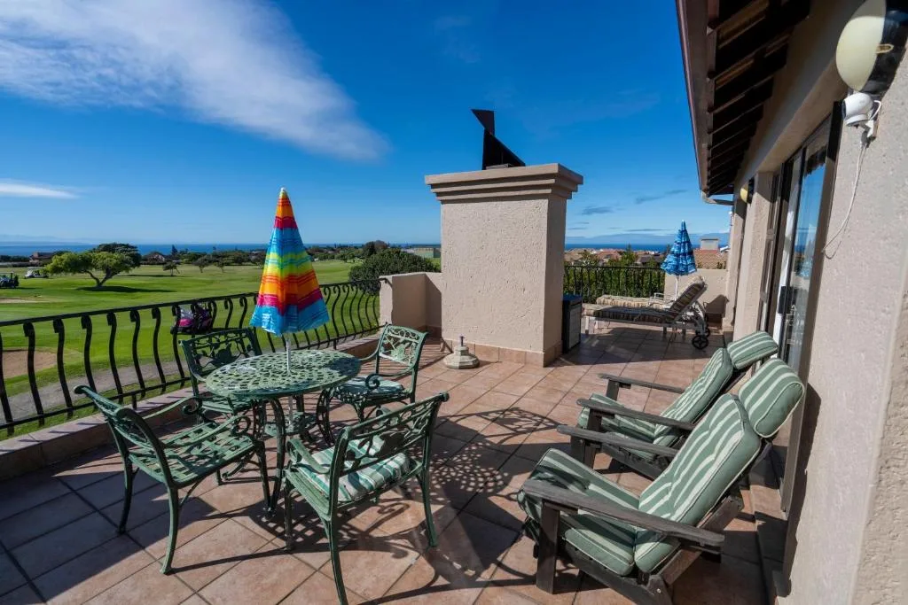Spacious patio with loungers overlooking golf course and ocean views