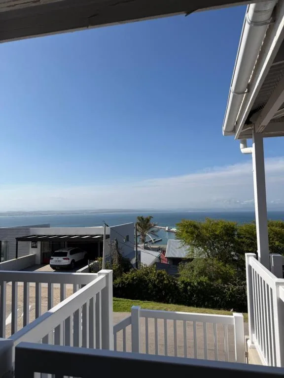Panoramic ocean and coastline view from elevated deck with railing