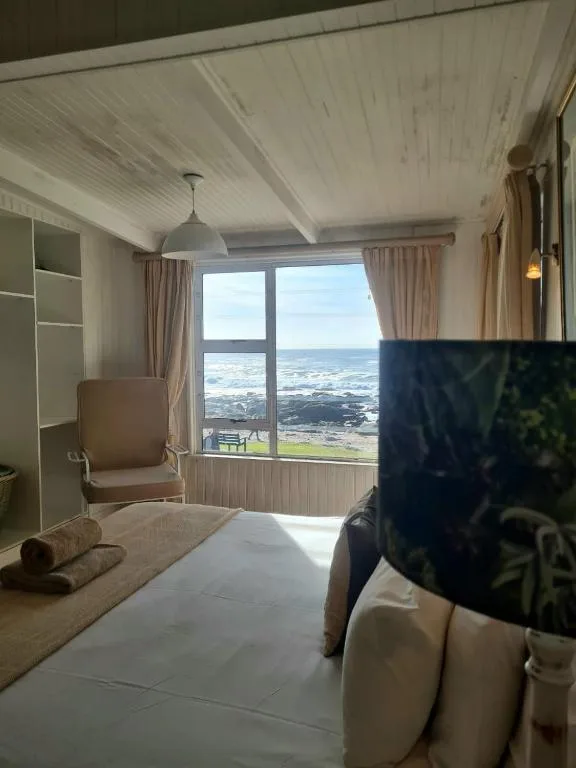 Bright bedroom with ocean and valley views through large windows