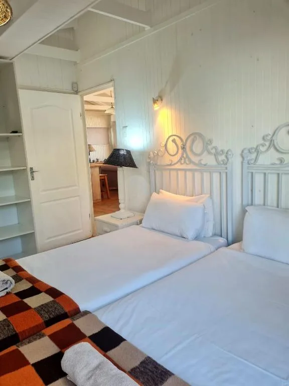 Bright bedroom with twin beds and ornate metal headboards