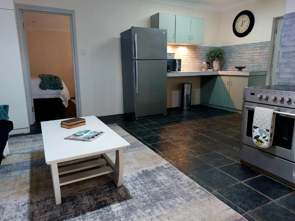 Modern kitchen with stainless steel appliances and mint cabinetry