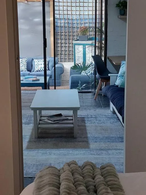 Open-plan lounge with coffee table, seating, and access to outdoor deck area