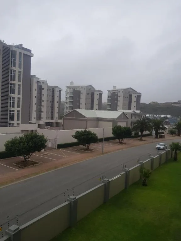 Modern apartment complex with manicured grounds and secure fencing