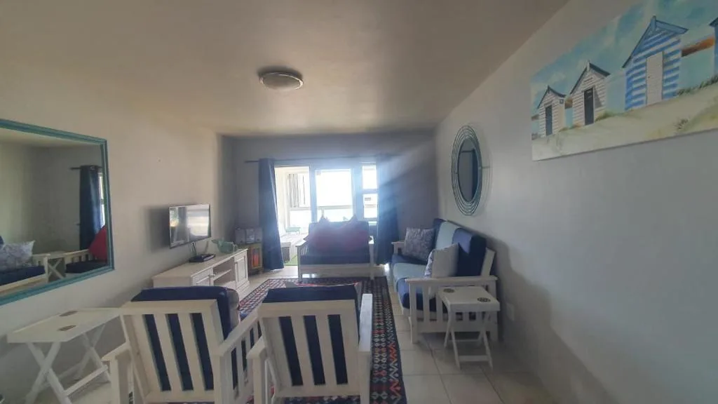 Bright living room with coastal decor, comfortable seating, and ocean views