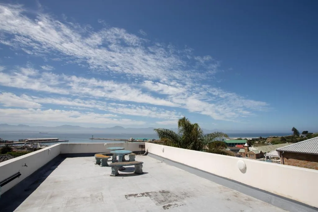 Expansive sea view from rooftop deck overlooking Mossel Bay harbor and mountains