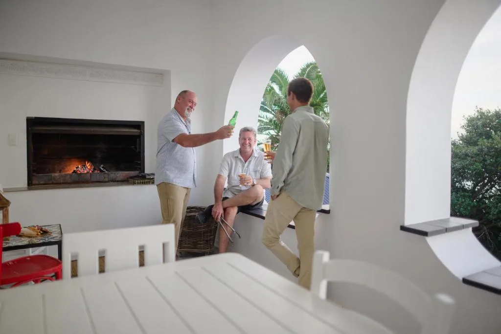 Modern white lounge with fireplace and guests socializing indoors