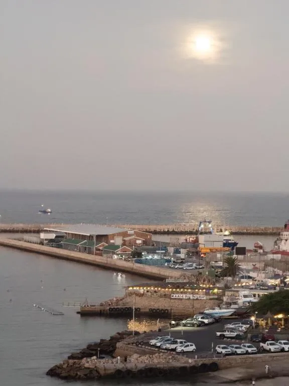 Mossel Bay harbor and waterfront at dusk with industrial port structures