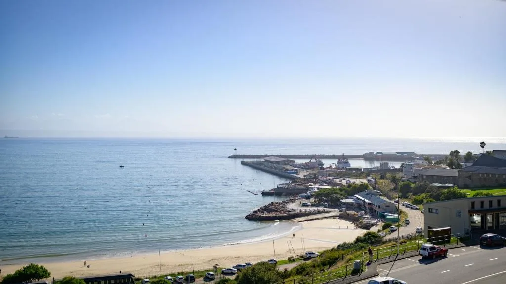 Scenic coastal view of Mossel Bay beach, harbor, and ocean landscape