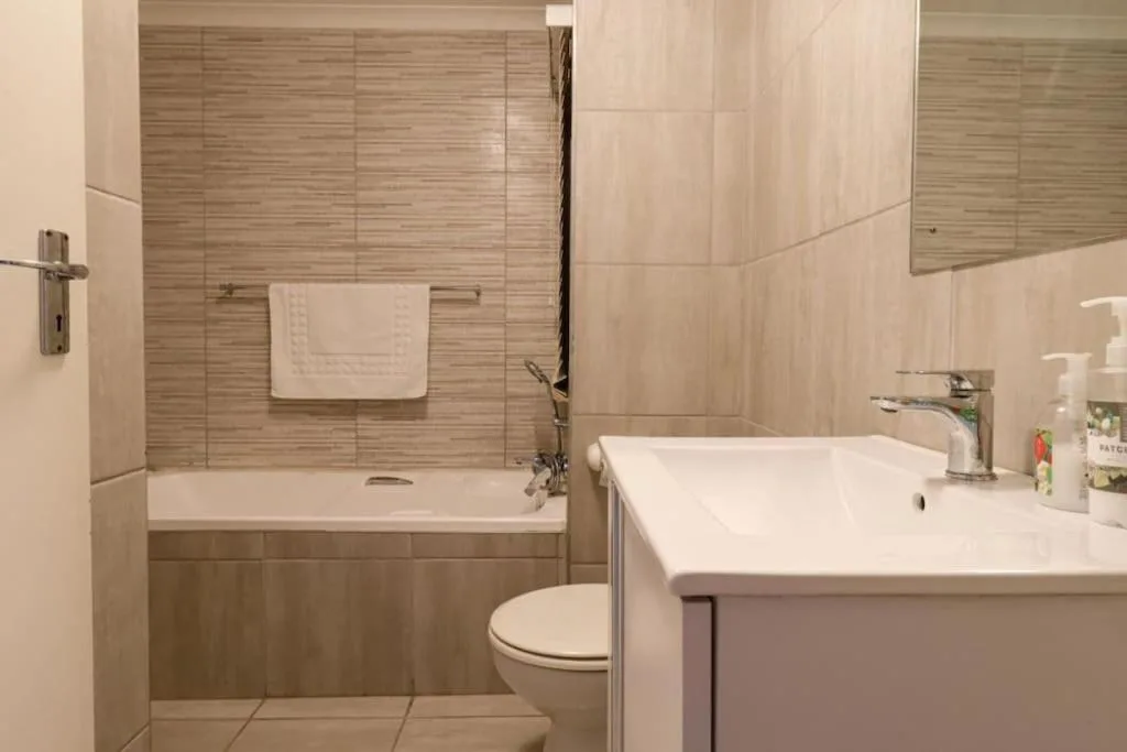 Modern bathroom with shower enclosure, toilet, and vanity sink