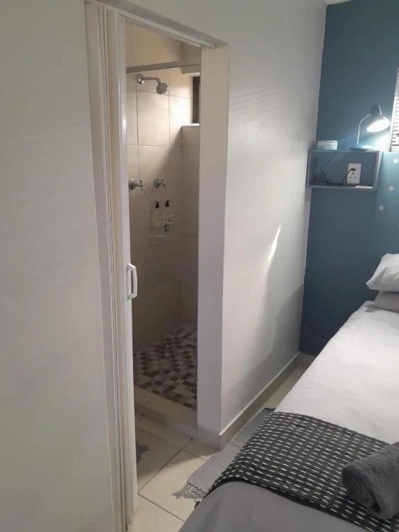 Modern ensuite shower room with glass enclosure and tiled floor