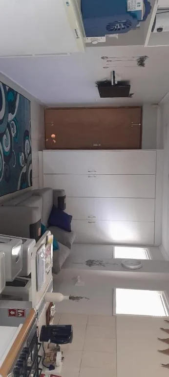 Bright bedroom with white built-in storage and brown headboard accent wall