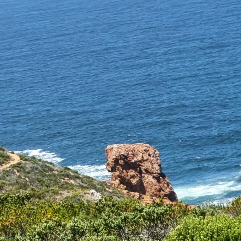 Scenic coastal view with rocky outcrop and turquoise ocean waters