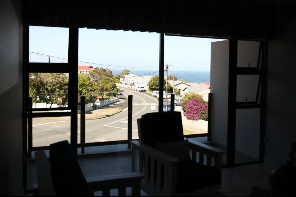 Scenic coastal view with beach and ocean visible through large windows