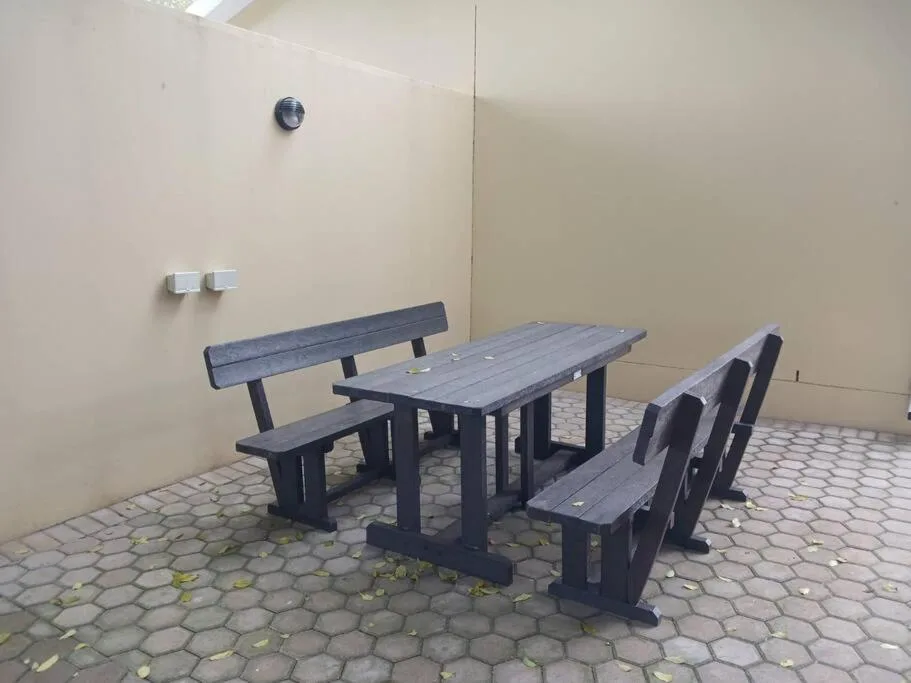 Outdoor picnic table and benches in covered patio area
