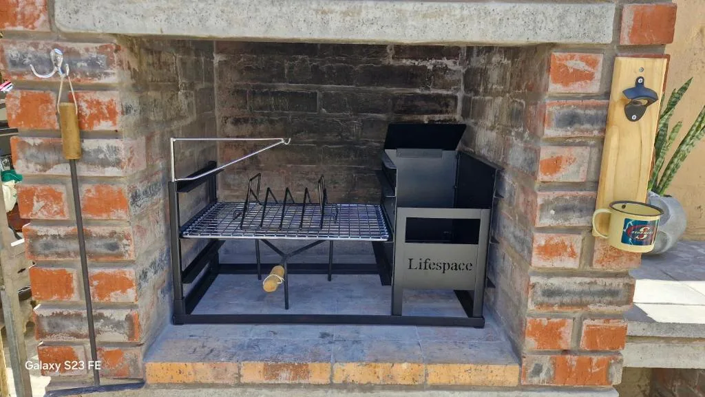 Built-in brick braai with grill grate and Lifespace chimney unit
