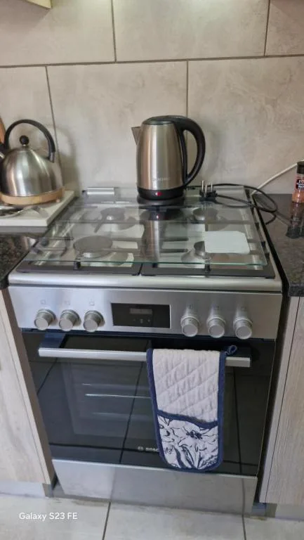 Modern stainless steel oven with electric cooktop and kitchen appliances