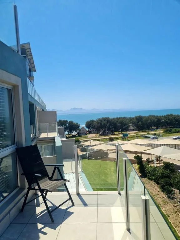 Ocean and lagoon views from a coastal balcony with seating area