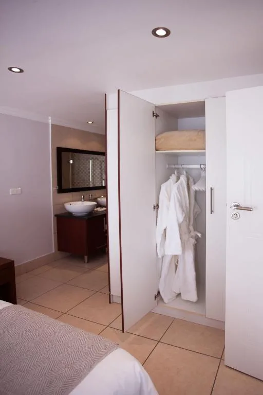 Modern bedroom with ensuite bathroom and built-in wardrobe with robes