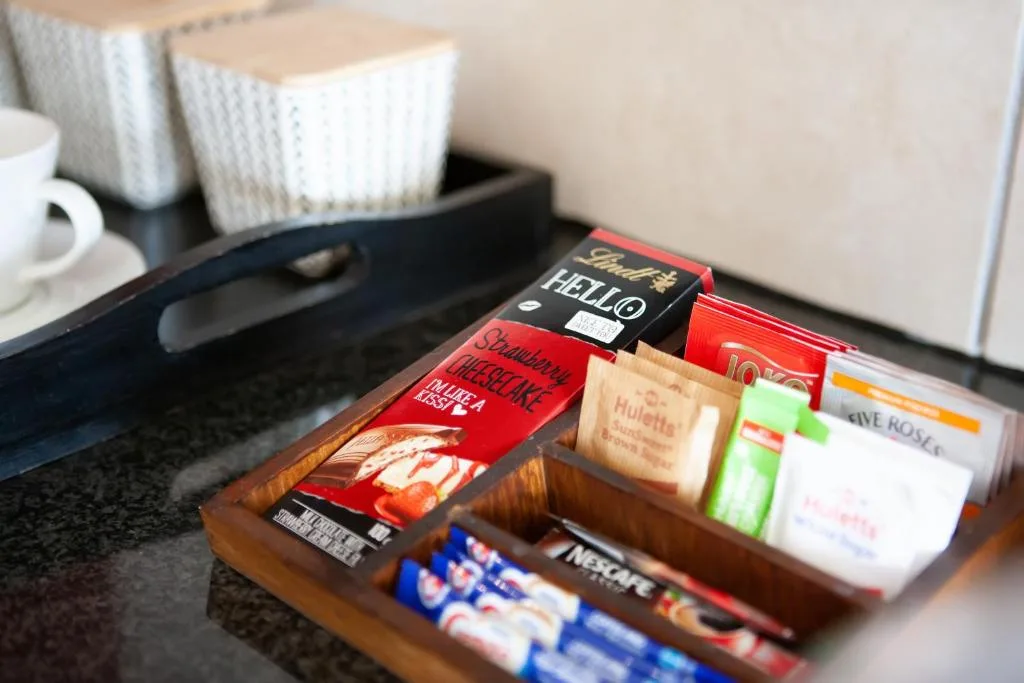 Welcome amenities tray with tea, coffee, and chocolate packets