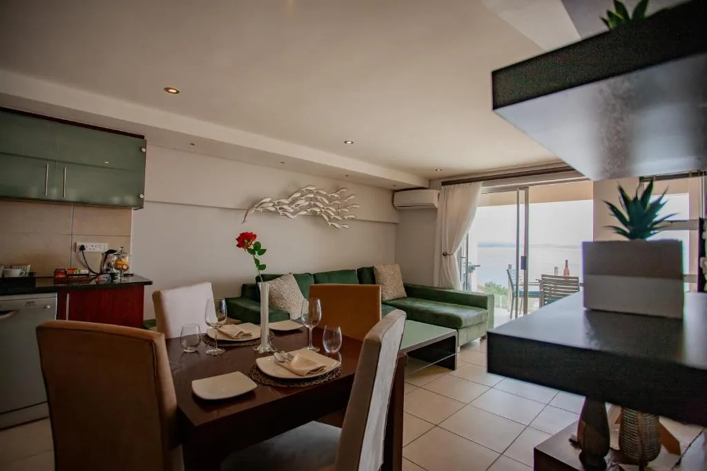 Modern dining table with place settings overlooking coastal views