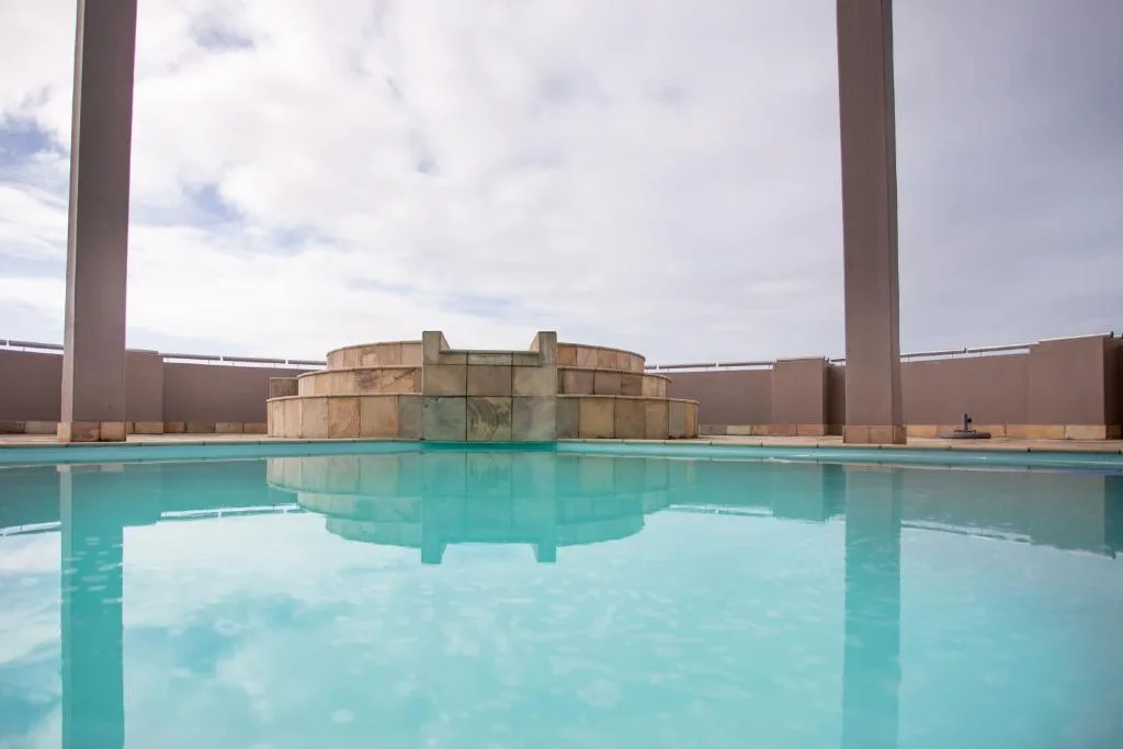 Indoor swimming pool with turquoise water and architectural features