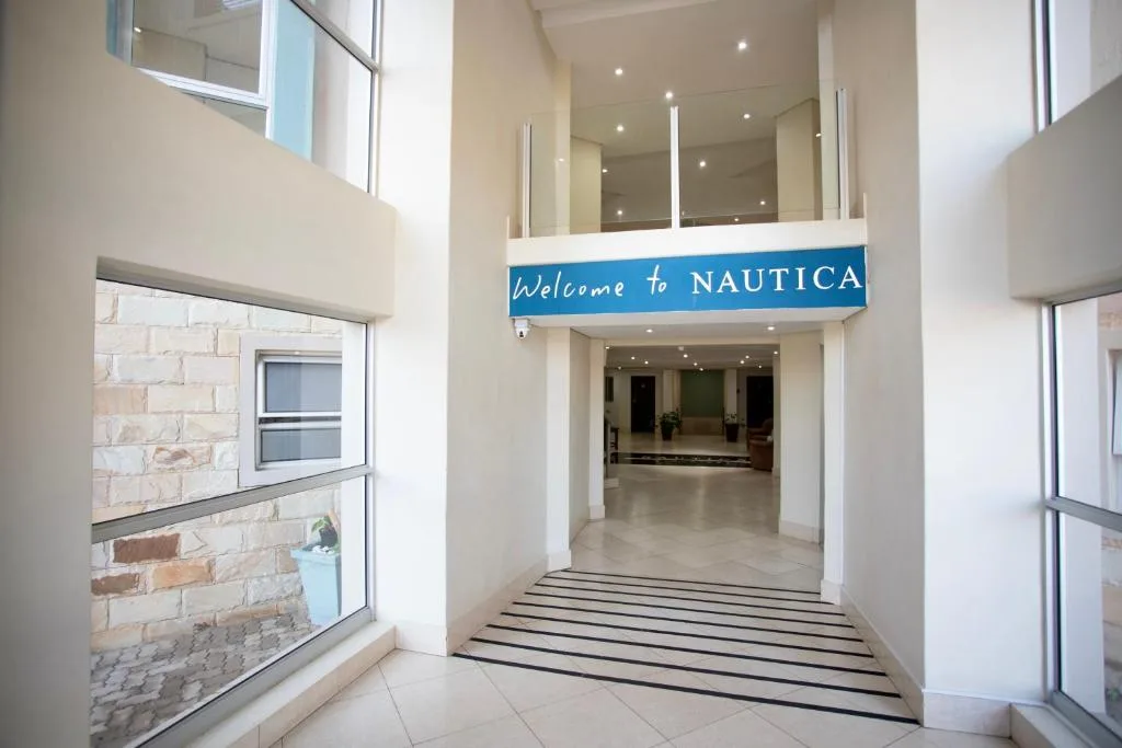 Modern entrance hallway with Welcome to Nautica signage and striped floor