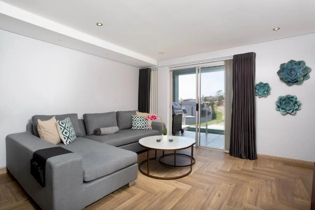 Modern living room with gray sectional sofa and contemporary furnishings