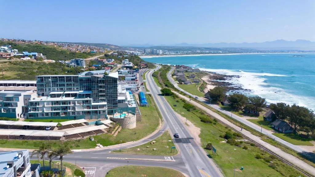 Turquoise ocean and coastal town vista from elevated property perspective