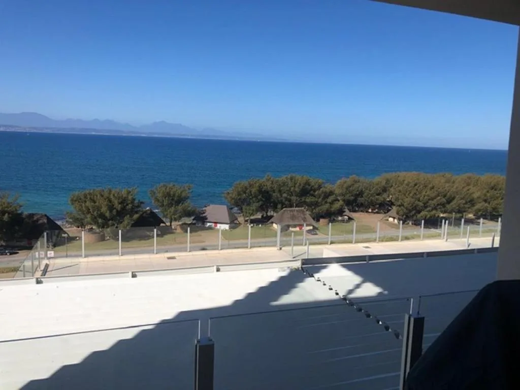 Coastal ocean view with mountains and beach from seaside property deck
