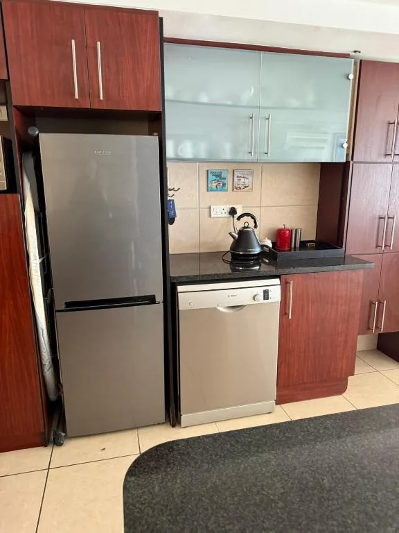 Modern kitchen with stainless steel appliances and wooden cabinetry