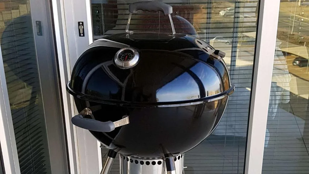 Close-up of black kettle-style braai grill on outdoor deck