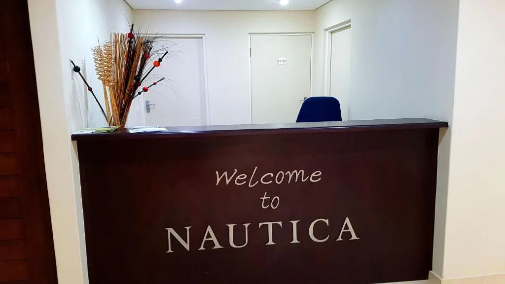 Welcome reception desk with decorative flowers and signage