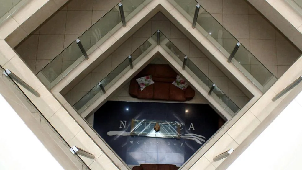Aerial view down multi-story building atrium with sea vista signage visible
