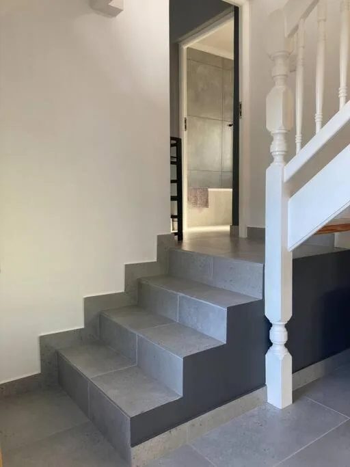 Modern concrete staircase with white bannister and open interior space