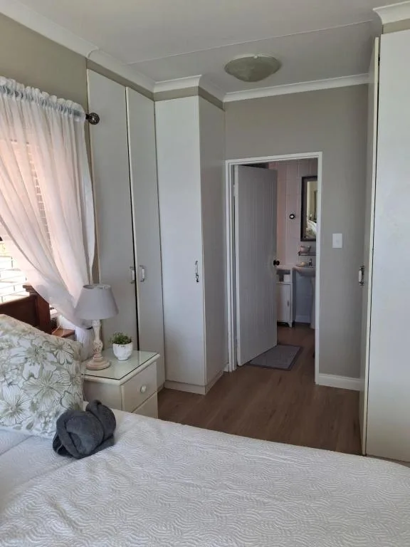 Spacious bedroom with double bed, built-in wardrobe, and ensuite access