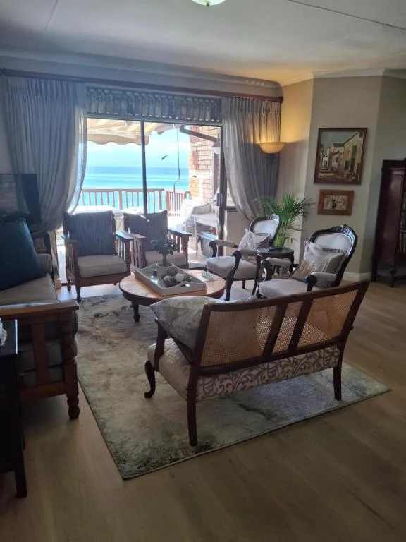 Elegant lounge with sea view through glass doors and curtains