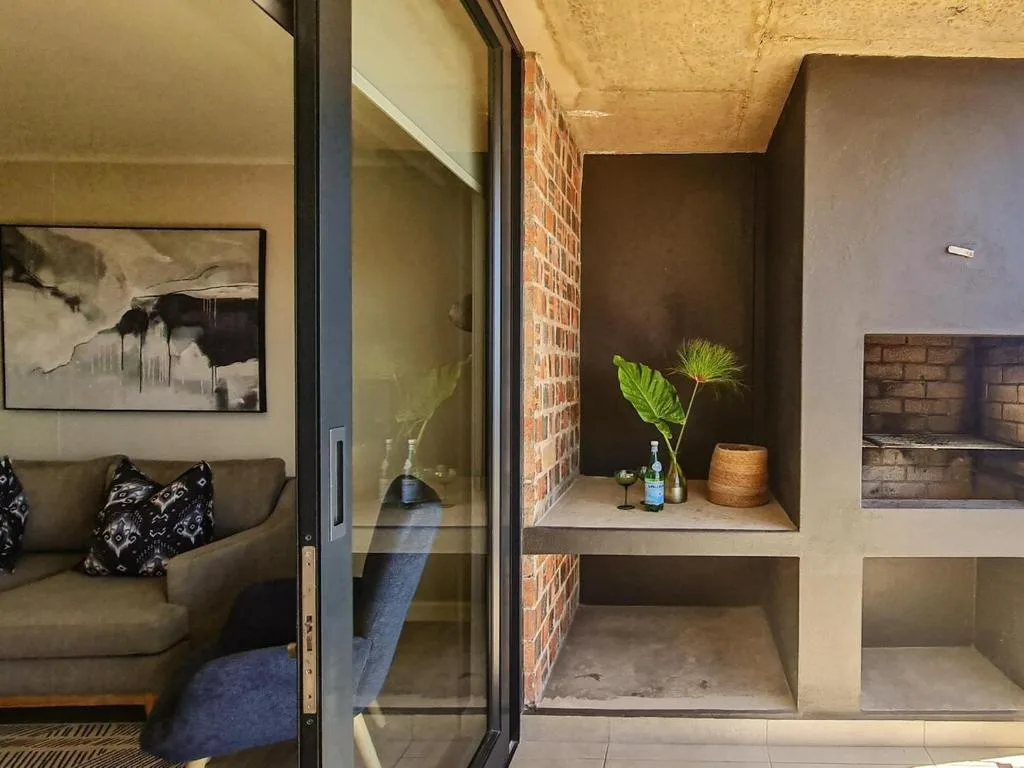 Built-in shelving alcove with decorative plant and minimalist styling